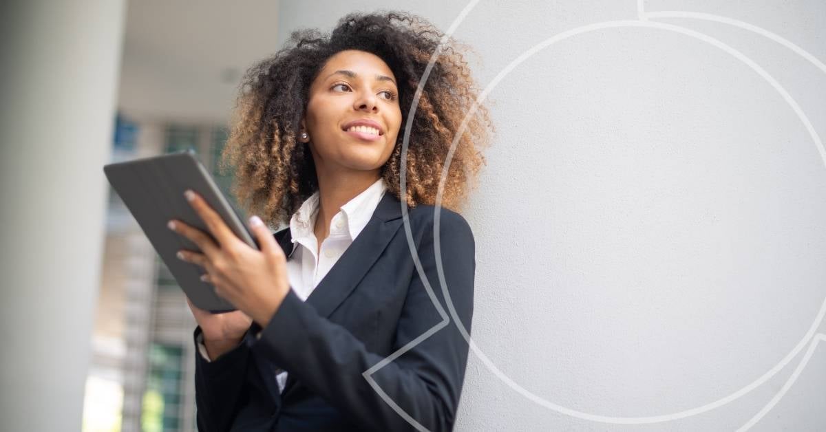 young professional woman smiling with tablet