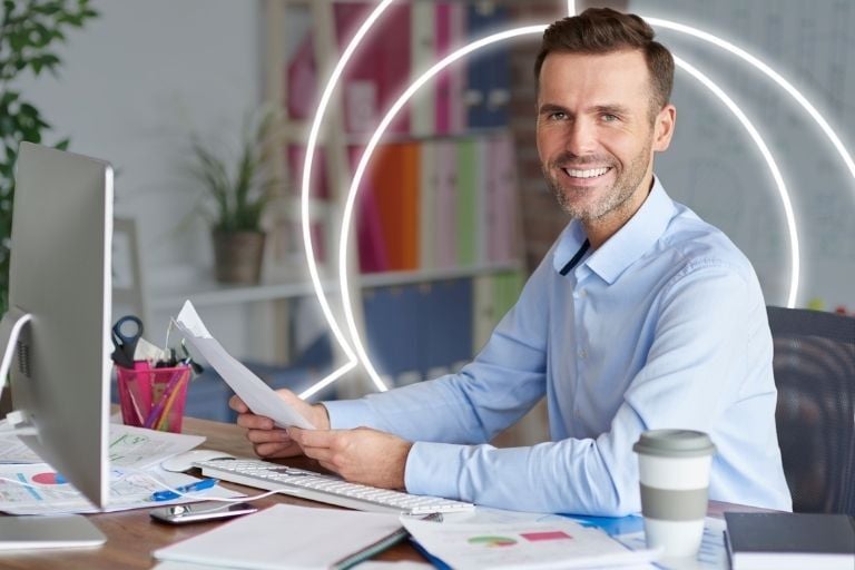 man working at desk facing camera