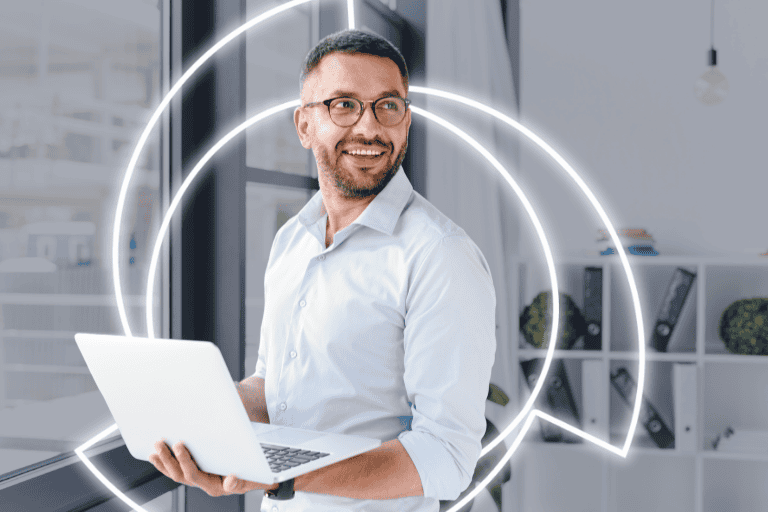 professionally dressed male standing with laptop in hand