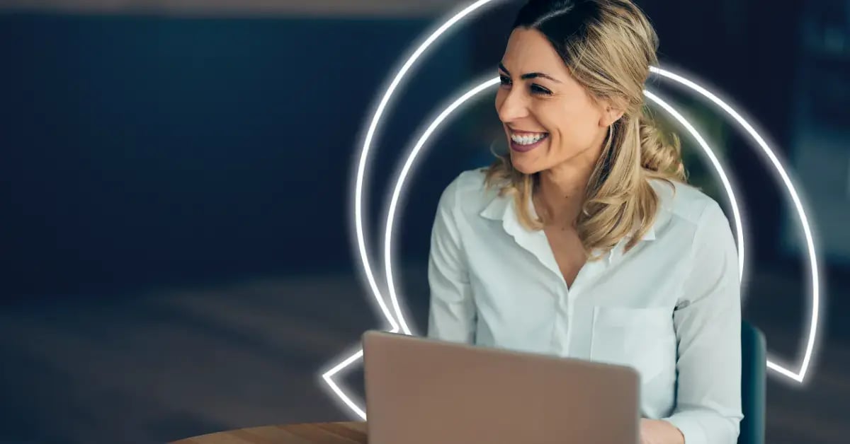 Woman Smiling with Laptop on desk