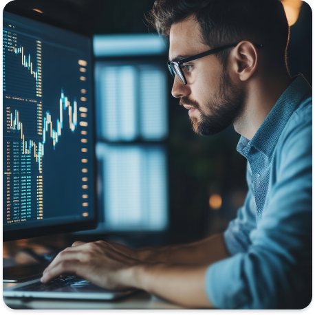 Commercial Debt Recovery Image - Man with glasses working at computer