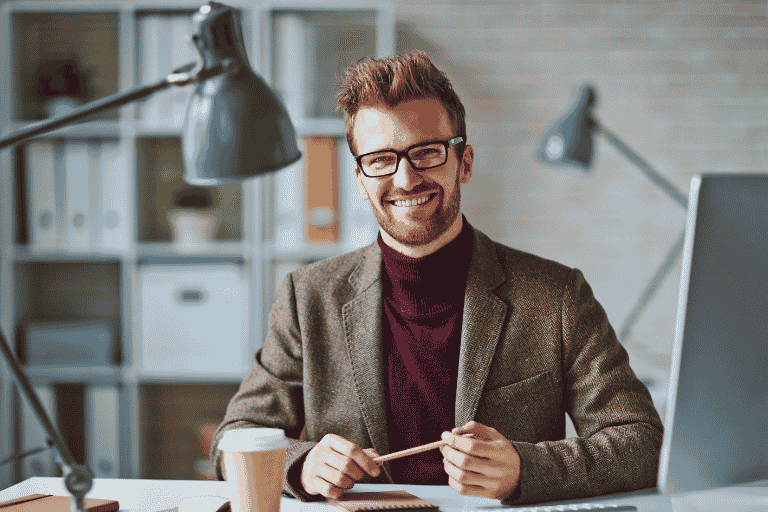young professional male seated at desk