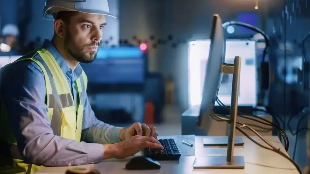 Construction Worker looking at desktop