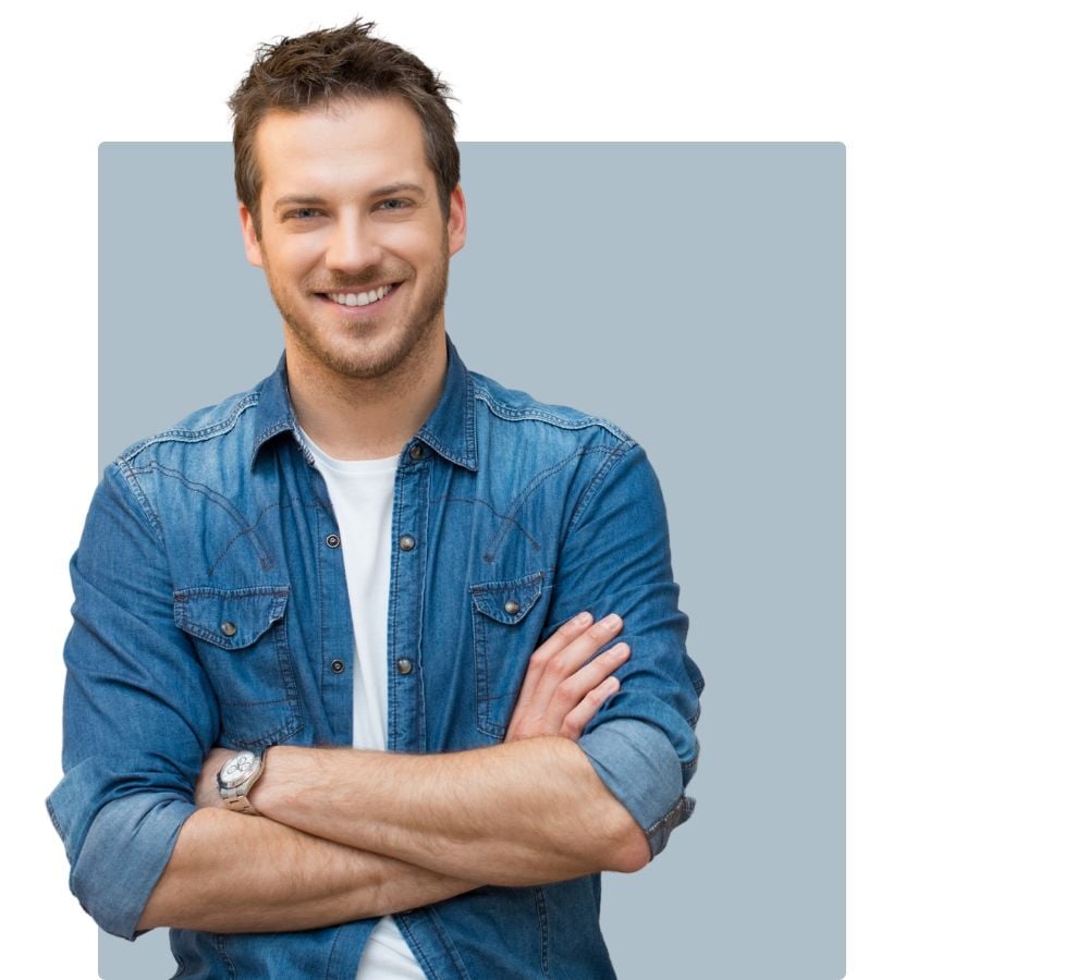 man in denim shirt arms crossed