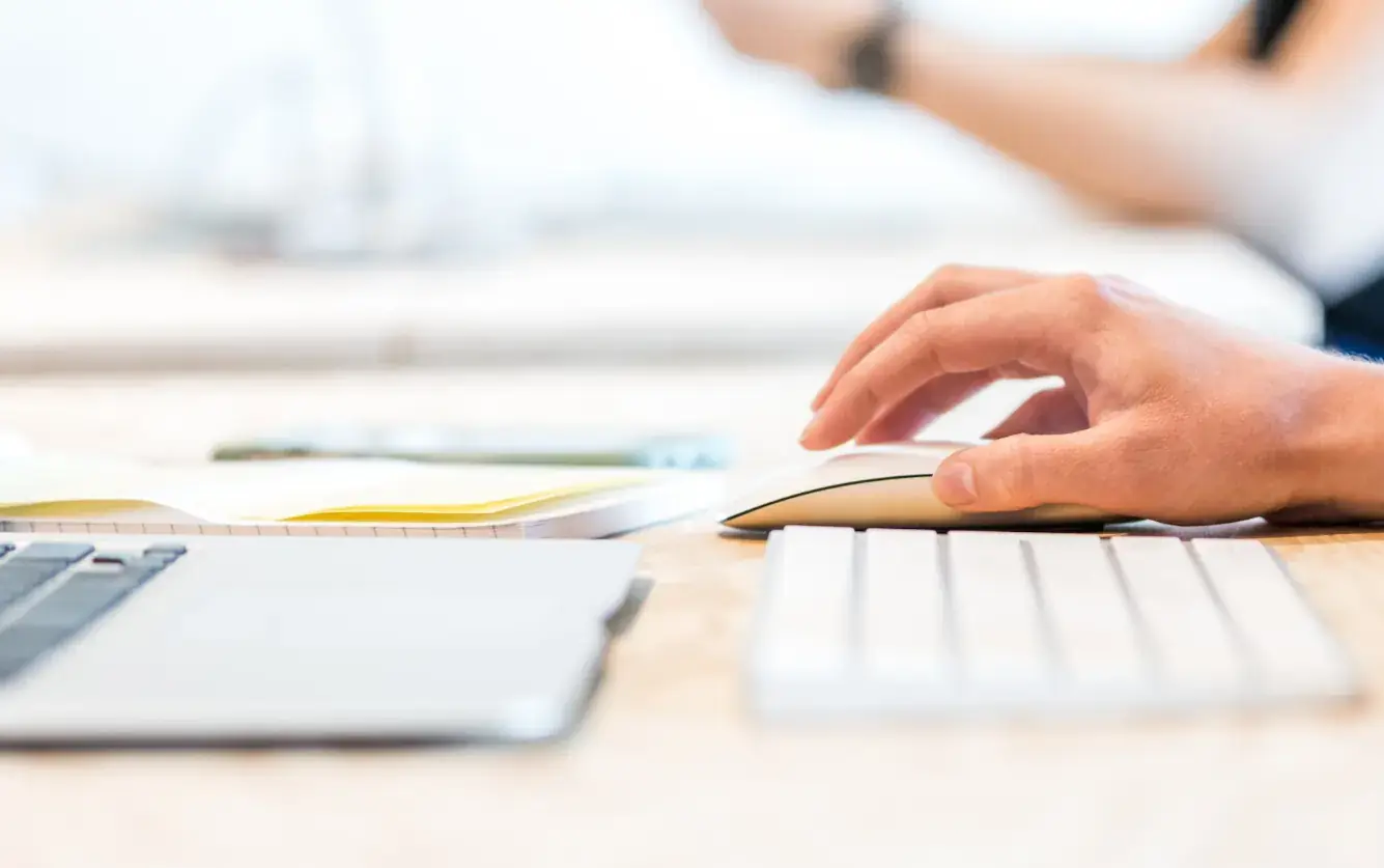 hand on mouse at computer