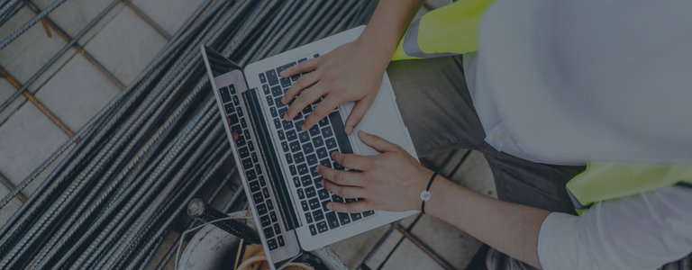 construction worker on site using laptop