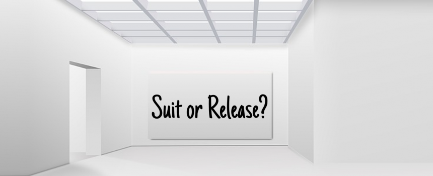 A picture containing indoor, cabinet, wall, facing sign that reads Suit or Release?