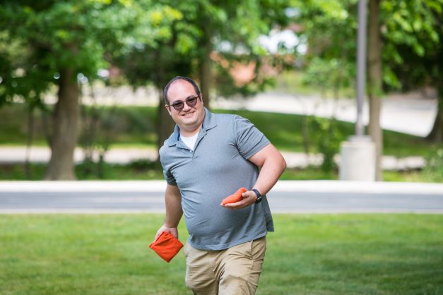 ncs credit team member playing cornhole