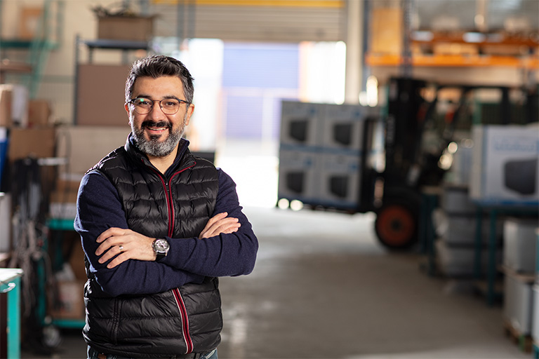 manufacturer standing in a warehouse