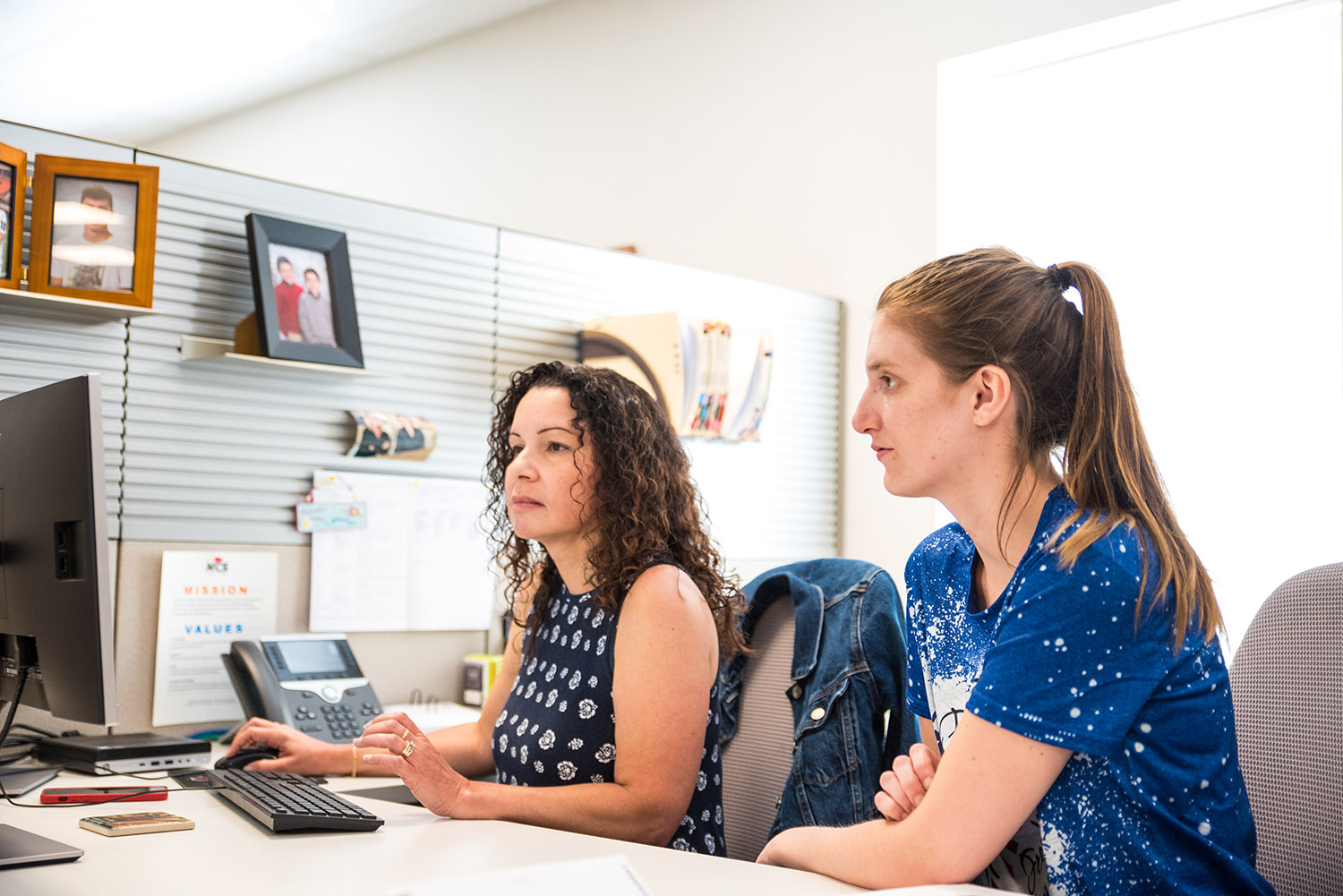 ncs credit employees working at a computer